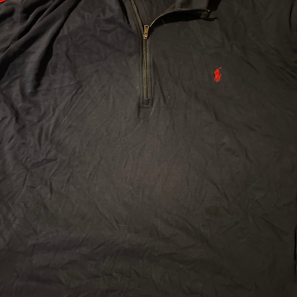 Polo with red striped, going down arm and shoulder